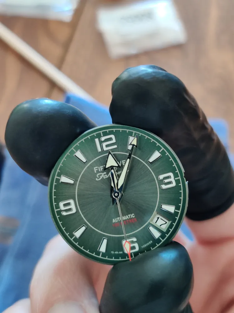 Macro shot of a green watch dial